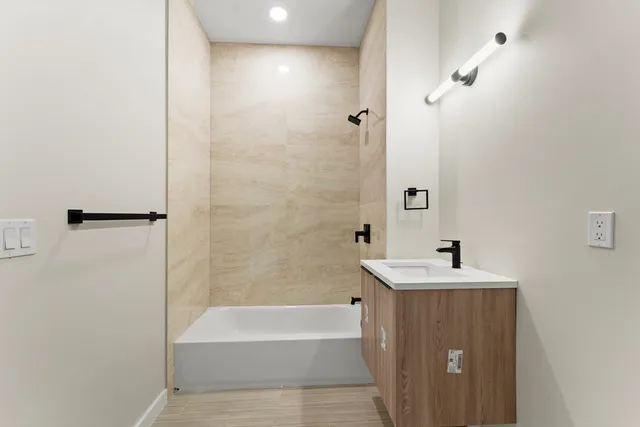 a bathroom with a bathtub and a sink