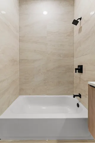 a bathroom with a bathtub and shower