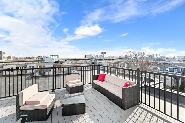 a view of a balcony with wooden benches