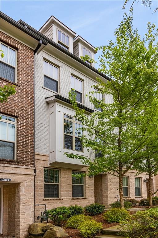 a front view of a residential apartment building with a yard