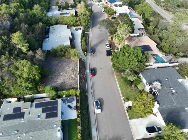an aerial view of a house with garden space and street view