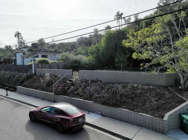 an aerial view of a house with garden space and street view