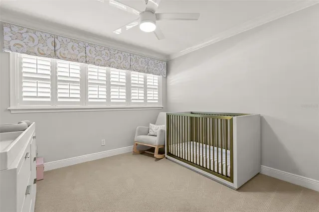 a view of a room with a window and a ceiling fan