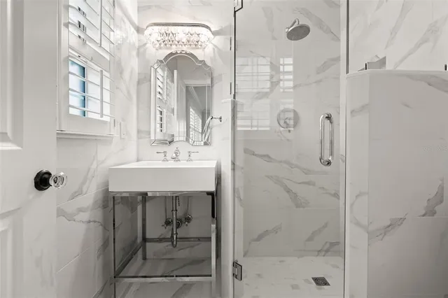 a bathroom with a shower sink and mirror