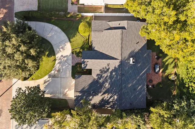 an aerial view of a house with a swimming pool
