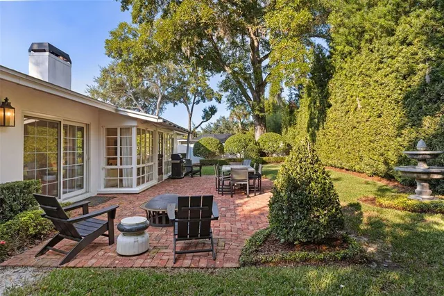 a view of a house with backyard sitting area and garden
