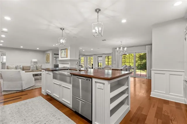 a kitchen with granite countertop a sink cabinets and wooden floor