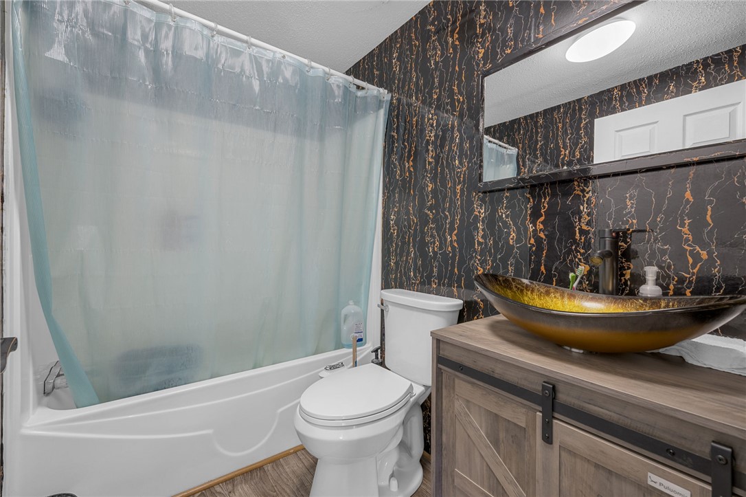 1549 Bethany Church Road Belton, SC 29627 - Photo 15 of 36 Bold patterned walls define this well-appointed bathroom featuring a unique vessel sink.