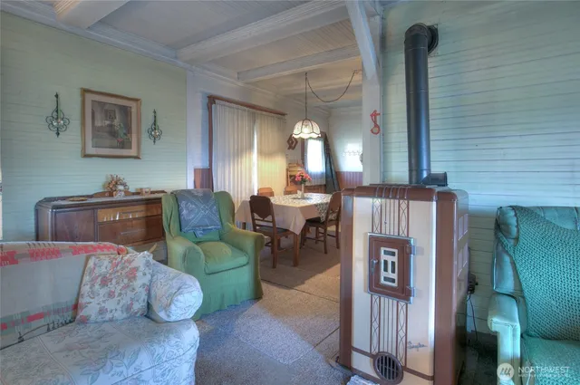 a living room with kitchen island furniture and a chandelier