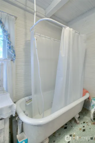 a bedroom with furniture and large window