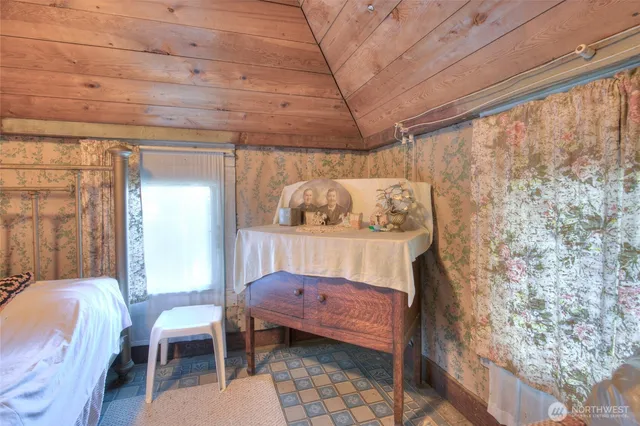 a bedroom with a bed and a table