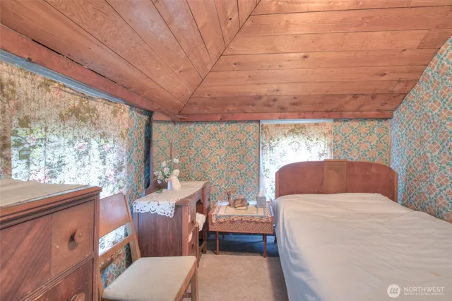 a bedroom with a bed and a desk