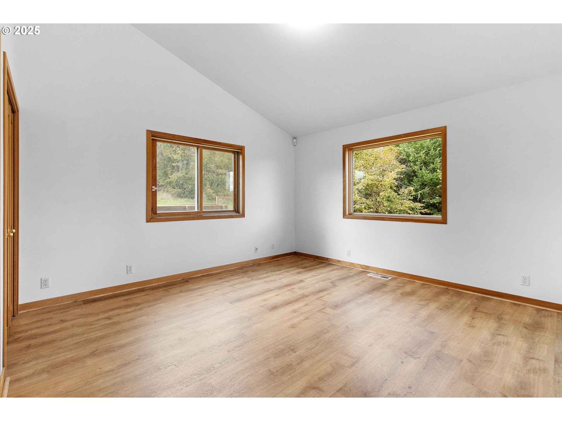 9325 Northeast Worden Hill Road Dundee, OR 97115 - Photo 17 of 48 a view of an empty room with window and wooden floor