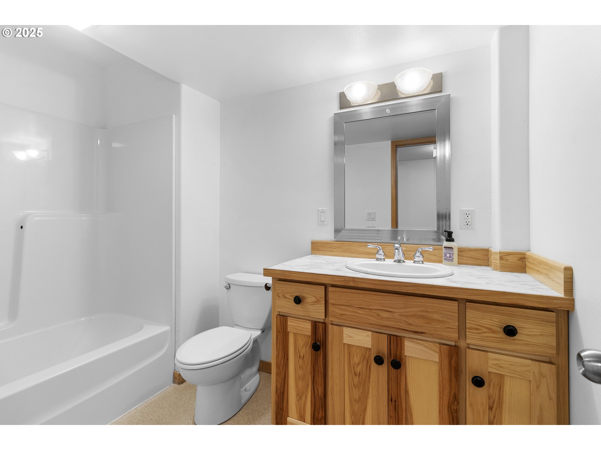 9325 Northeast Worden Hill Road Dundee, OR 97115 - Photo 22 of 48 a bathroom with a granite countertop sink a toilet mirror and bathtub