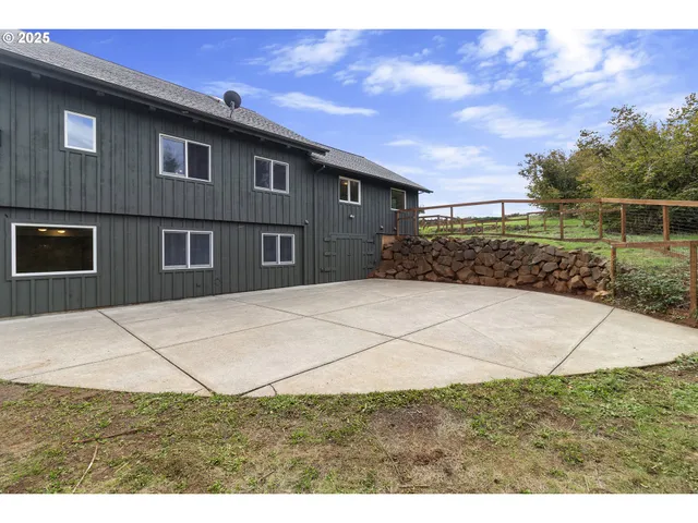 a kitchen with granite countertop a sink cabinets stainless steel appliances and a window