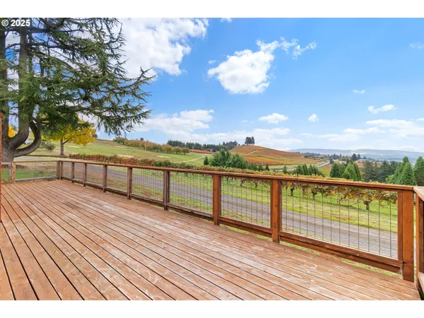 a view of a house with a big yard and large trees
