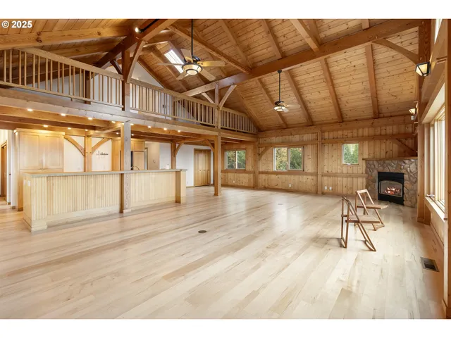a view of a hallway with a couch and chandelier