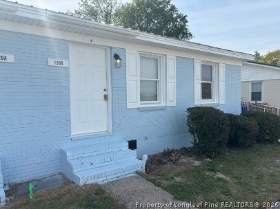 120 Calvin Street, Unit B Spring Lake, NC 28390 - Photo 2 of 7 a front view of a house with a garden