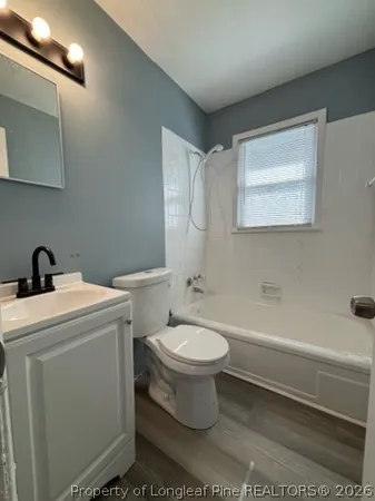 a bathroom with a toilet a sink and bathtub