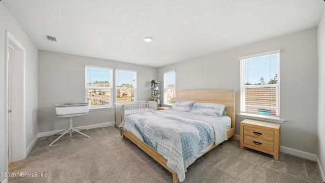 a bedroom with a bed and a desk