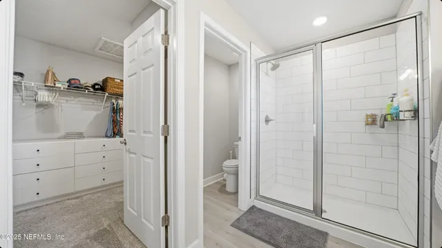 a bathroom with a shower and a sink