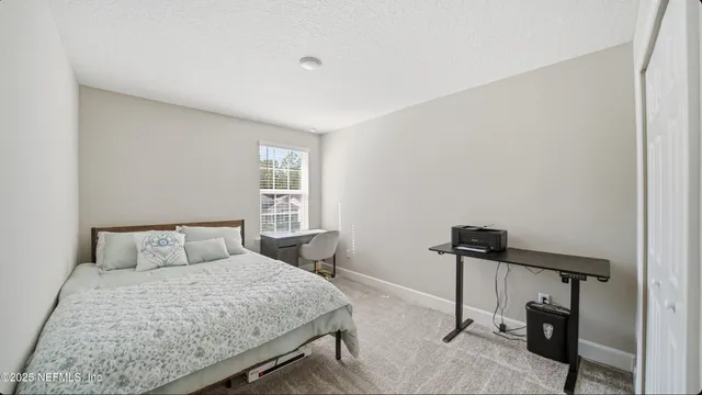 a bedroom with a bed and a table in it