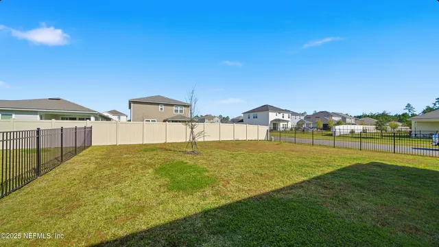 a view of a house with a yard and garage