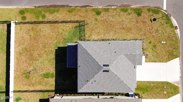 an aerial view of a house with a swimming pool