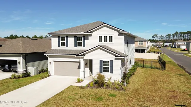 an aerial view of a house with a lake view