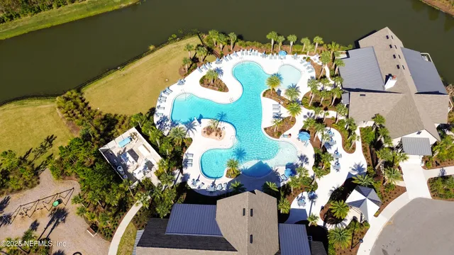 an aerial view of a house with a lake view
