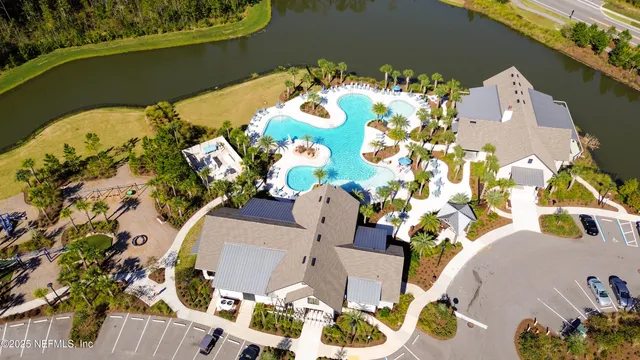 an aerial view of a house with a yard and lake view
