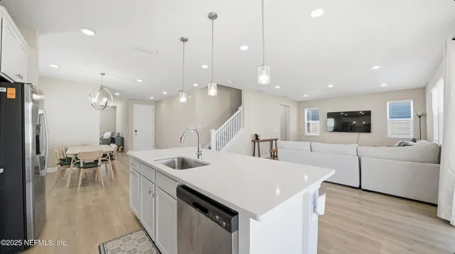 a kitchen with a sink a table and chairs