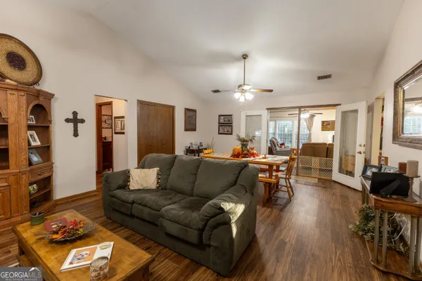 a living room with furniture and wooden floor