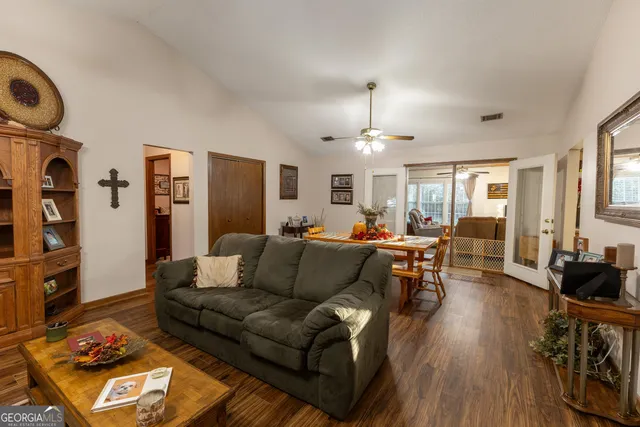 a living room with furniture and wooden floor