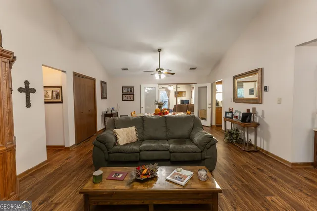 a living room with furniture and a wooden floor