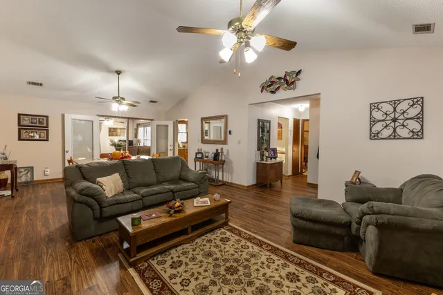 a living room with furniture and wooden floor