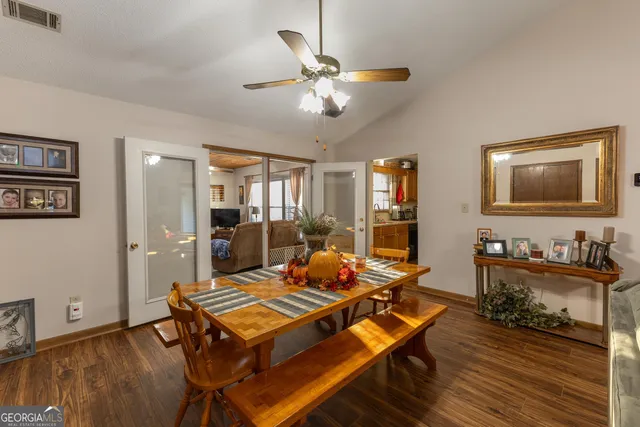 a living room with furniture a table and wooden floor
