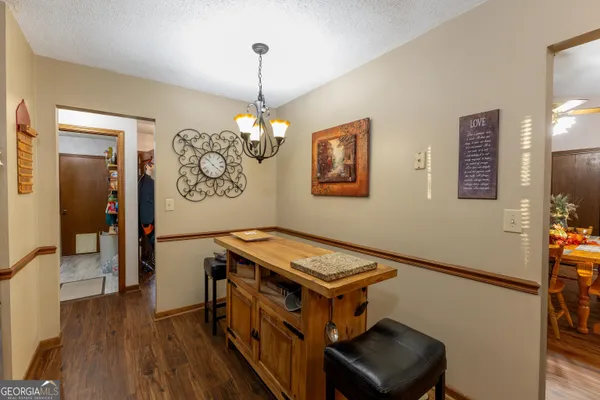 a kitchen with stainless steel appliances a stove a refrigerator and a chandelier