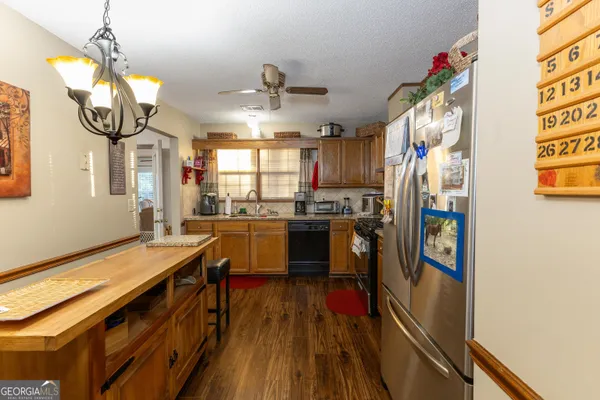 a living room with furniture a flat screen tv and a large window