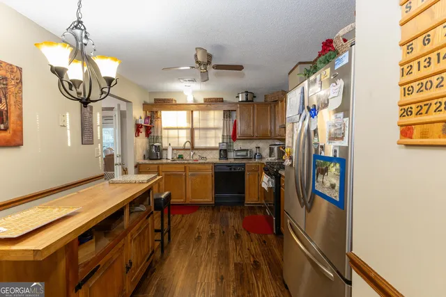 a living room with furniture a flat screen tv and a large window