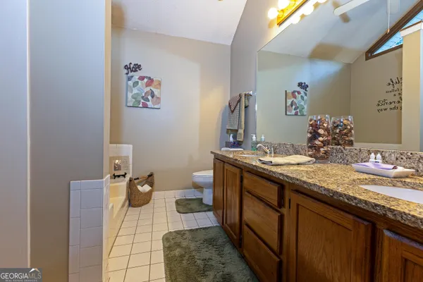 a bathroom with a bathtub and a white wall