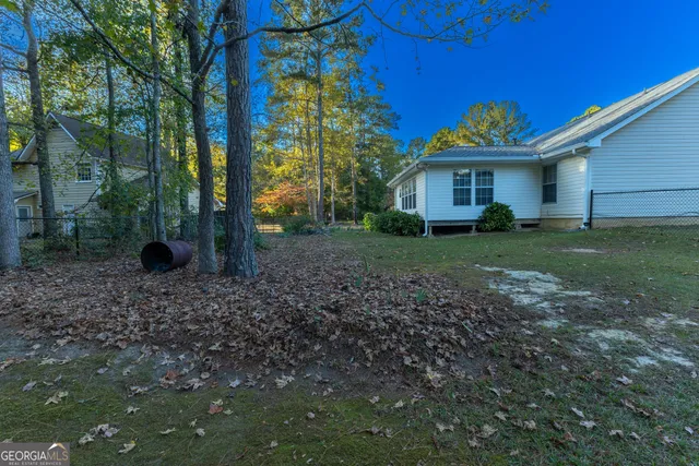 a view of a backyard with a garden and trees