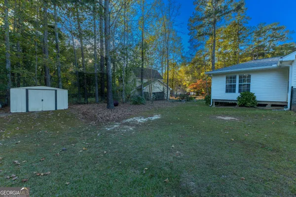 a view of house with outdoor space and sitting area
