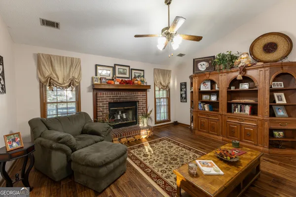 a living room with furniture and a fireplace