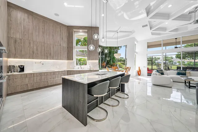 a living room with patio furniture and a flat screen tv