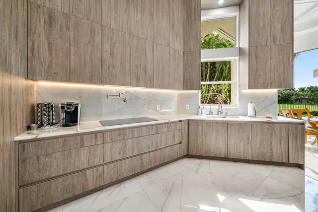 a bedroom with a bed a desk and chair with wooden floor