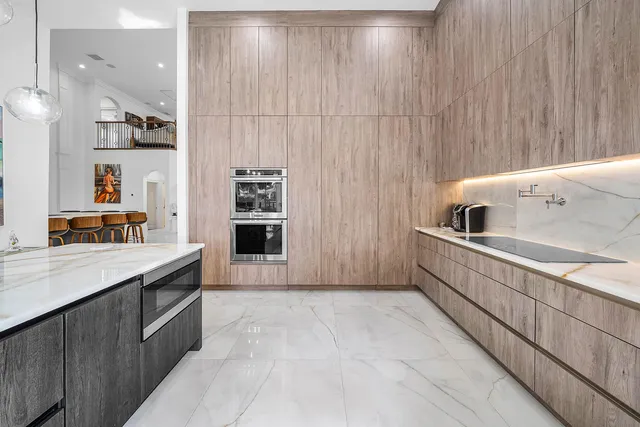 a bedroom with a bed tv and chair