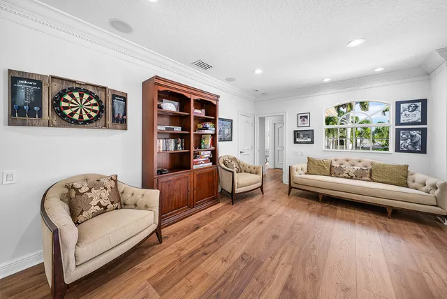 a spacious bedroom with furniture and a chandelier