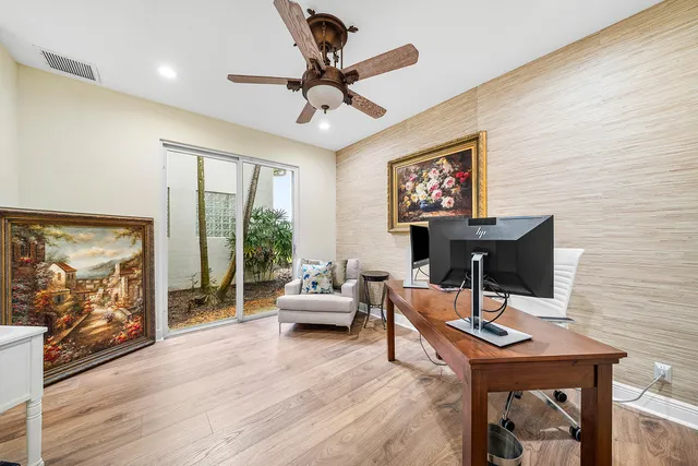 an aerial view of a house with a yard and trees