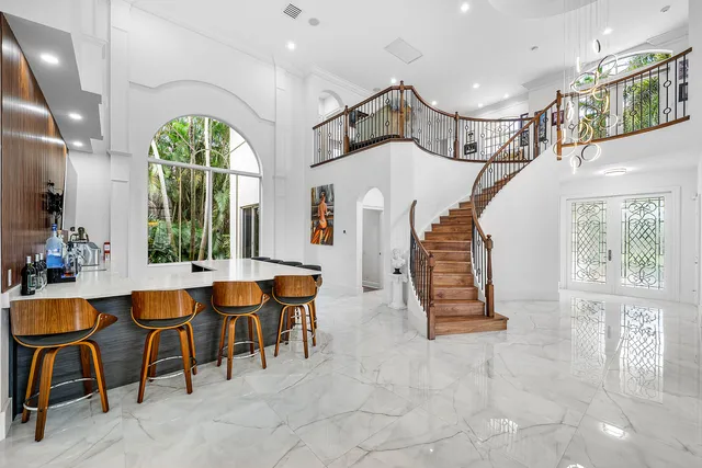 a view of a workspace with furniture and a book shelf